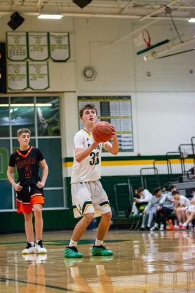 Remaining calm, Freshman Luke Woods takes his time on his free throws versus Shawnee Mission Northwest on Feb. 5.