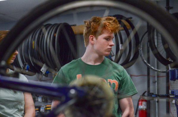 Junior Will Brush looks off to the side during the bike club meeting at Hannover Bikes on Feb. 18.