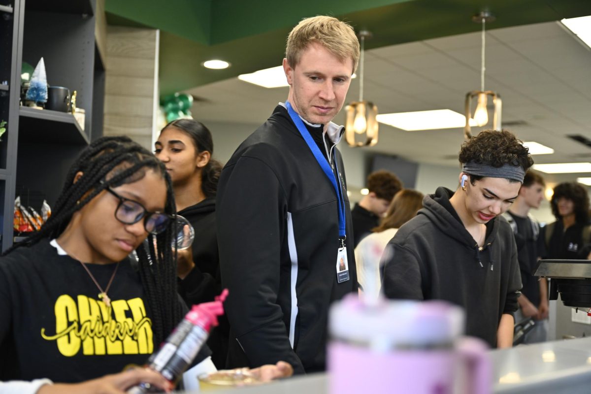 Josh Oldenettel, alongside Genesis Brewer and Jeordy Ford, oversees operations at the green bean during seminar on Feb. 27. 

