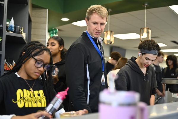 Josh Oldenettel, alongside Genesis Brewer and Jeordy Ford, oversees operations at the green bean during seminar on Feb. 27.