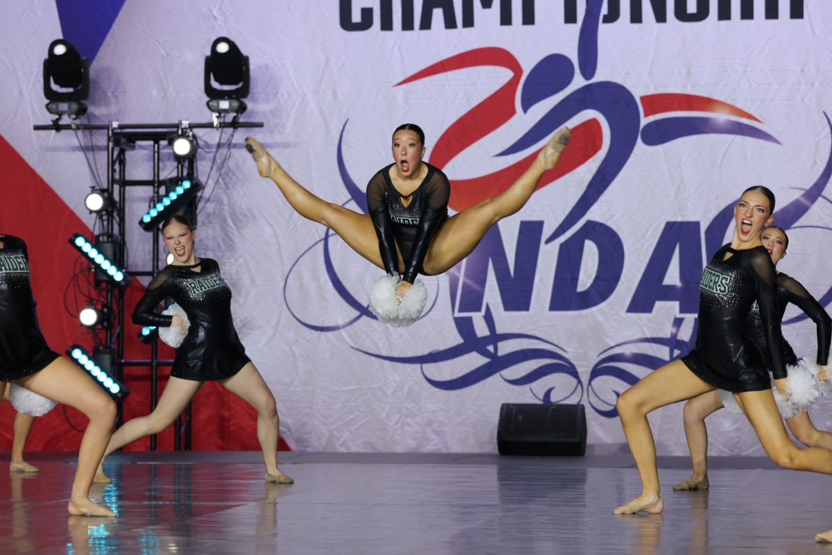 Senior Elise Pai does a jump during their routine. 
