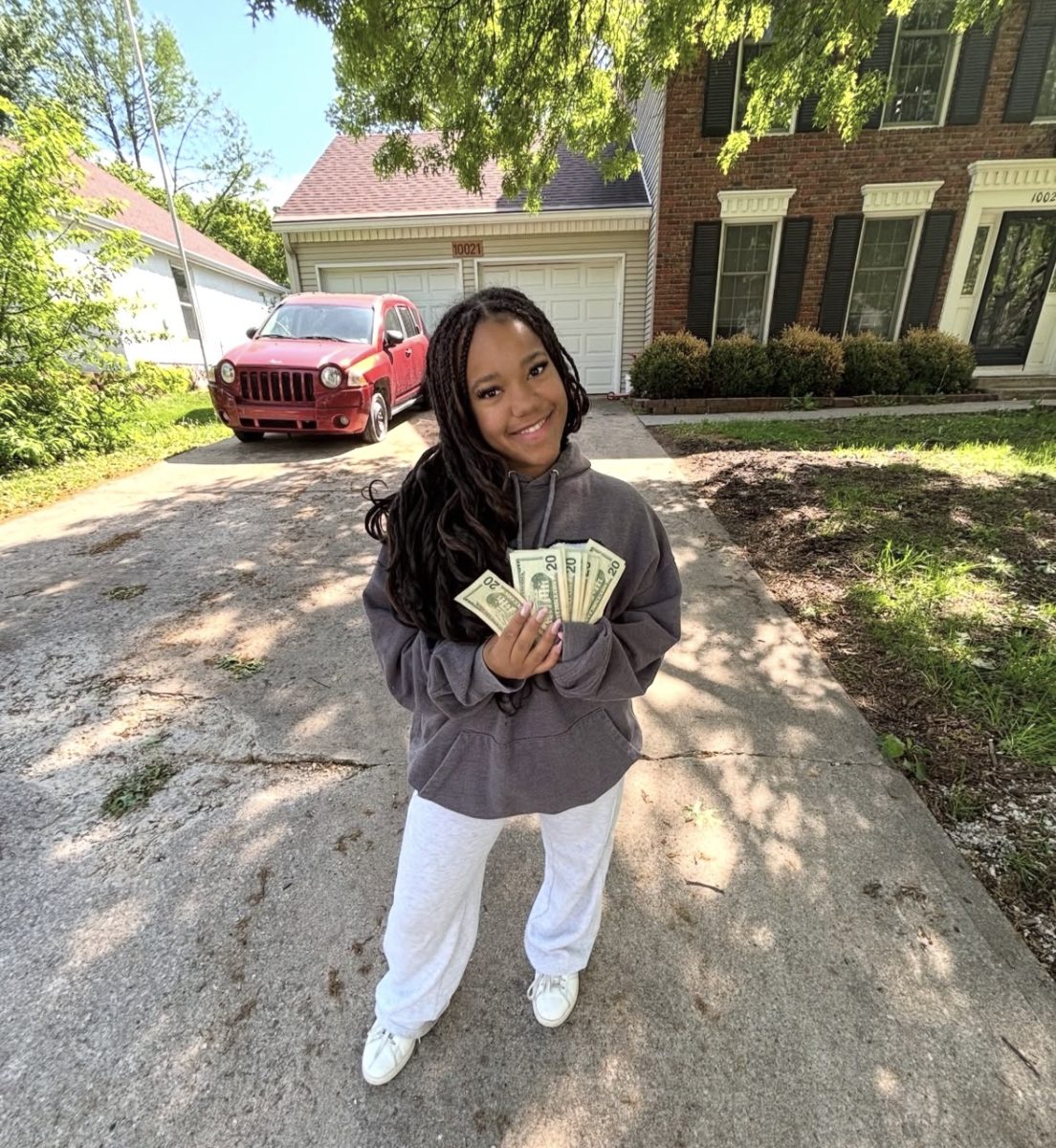 Senior Denah Thomas stands with her cash prize for winning 