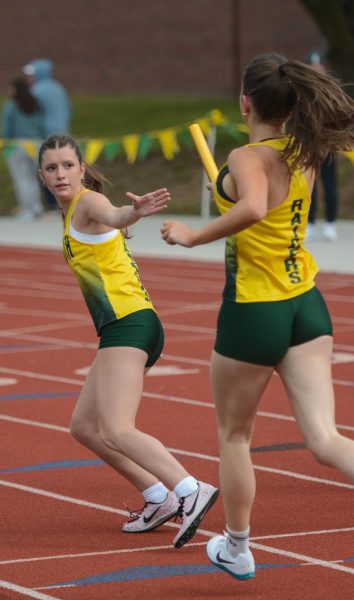 Finishing strong, sophomore Murphy Brassel hands the baton off to sophomore Megan Wright at South Relays on April 4.